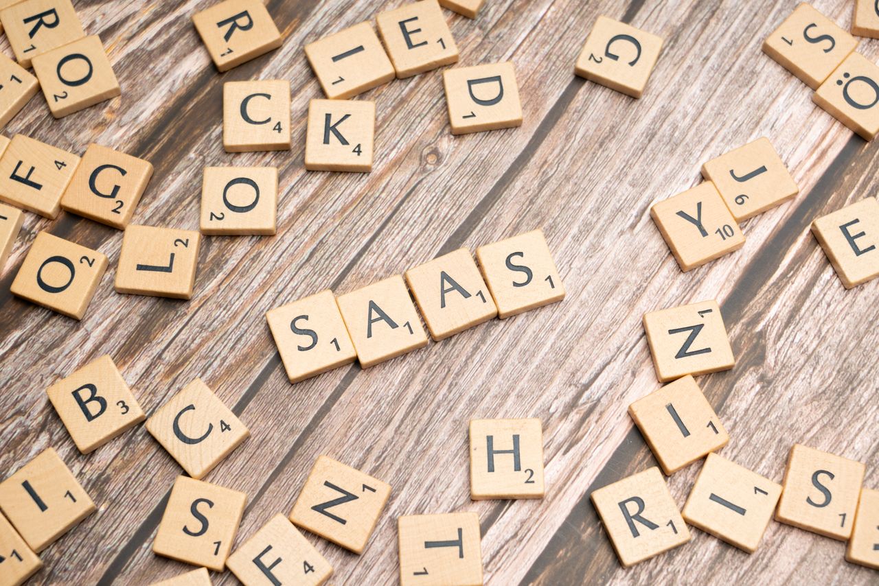 Home Wooden letter tiles spelling SaaS on rustic wood. Ideal for cloud computing and business concepts.