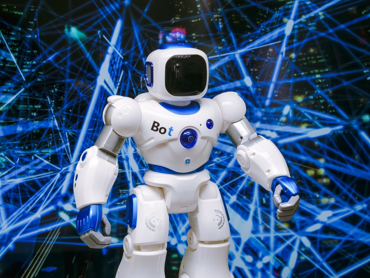 About Advanced humanoid robot with glowing blue accents in a digital network setting.
